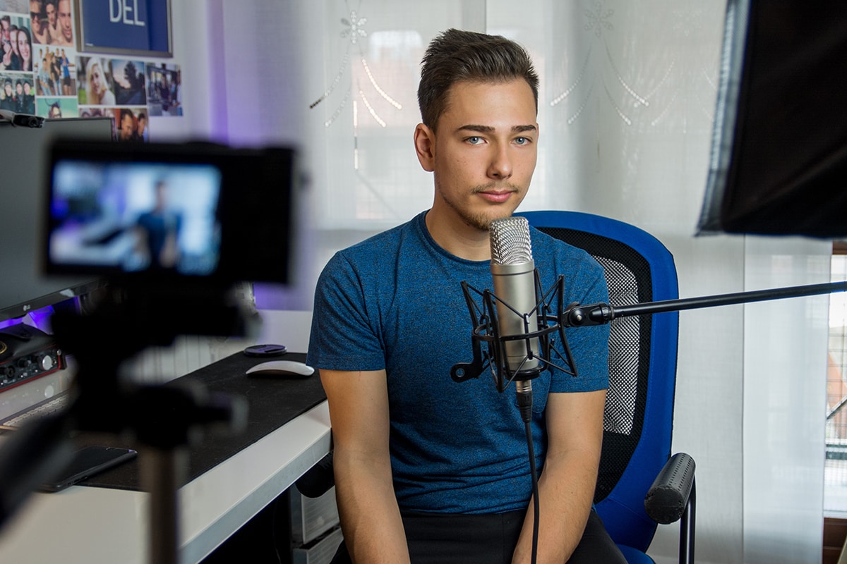 A male college student records a video for YouTube