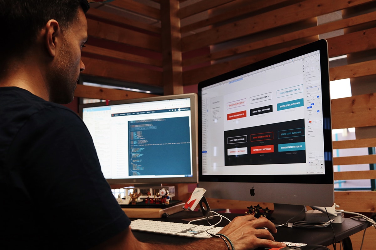 Male college student coding a website